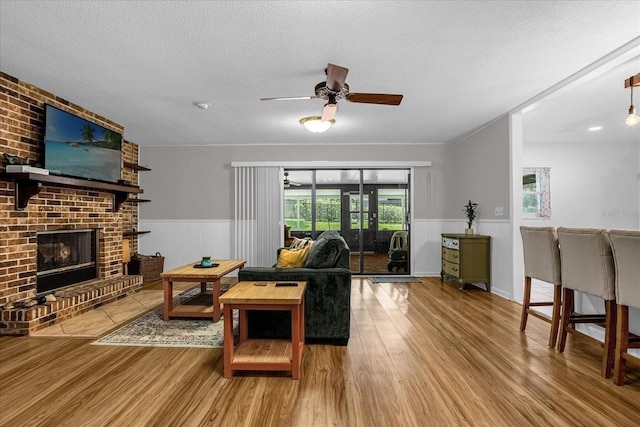 living room featuring a fireplace, hardwood / wood-style floors, and a textured ceiling