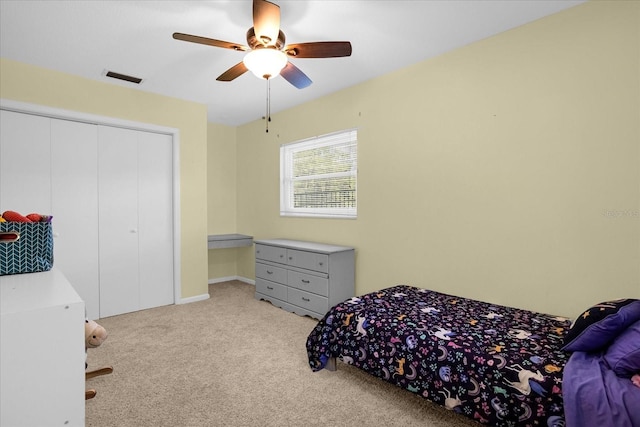 carpeted bedroom featuring a closet and ceiling fan