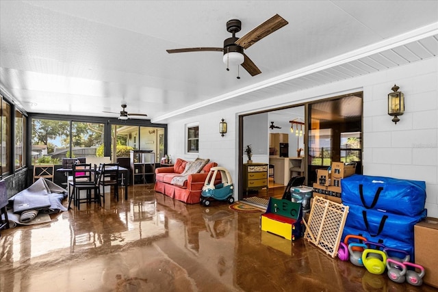 sunroom / solarium featuring ceiling fan