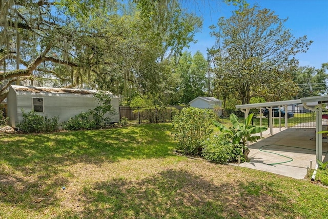 view of yard featuring a storage shed and a carport