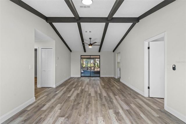 unfurnished living room with ceiling fan, light hardwood / wood-style flooring, and vaulted ceiling with beams