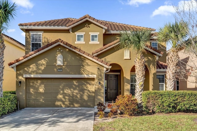 mediterranean / spanish-style house with a garage