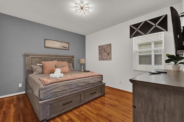 bedroom with dark hardwood / wood-style floors