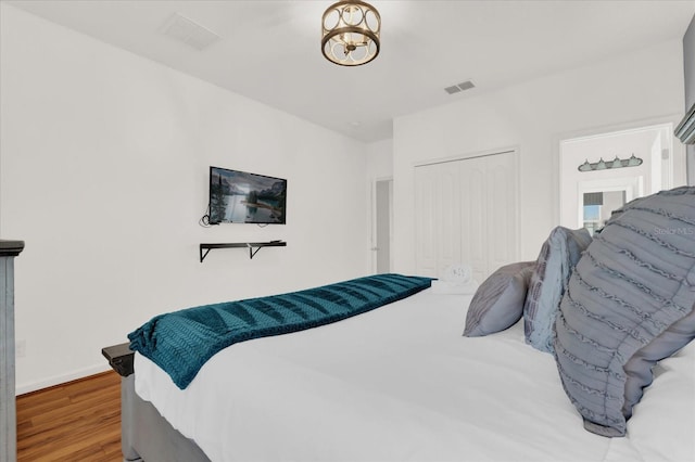 bedroom featuring wood-type flooring and a closet