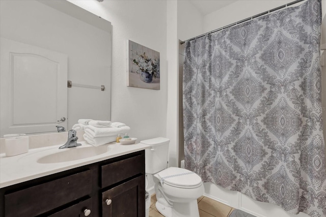 bathroom with tile patterned floors, vanity, and toilet