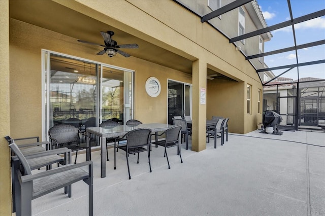 view of patio featuring a lanai and ceiling fan