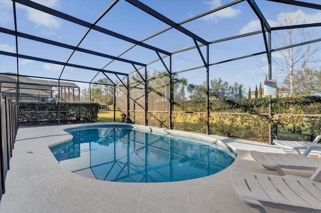 view of pool with a patio and glass enclosure