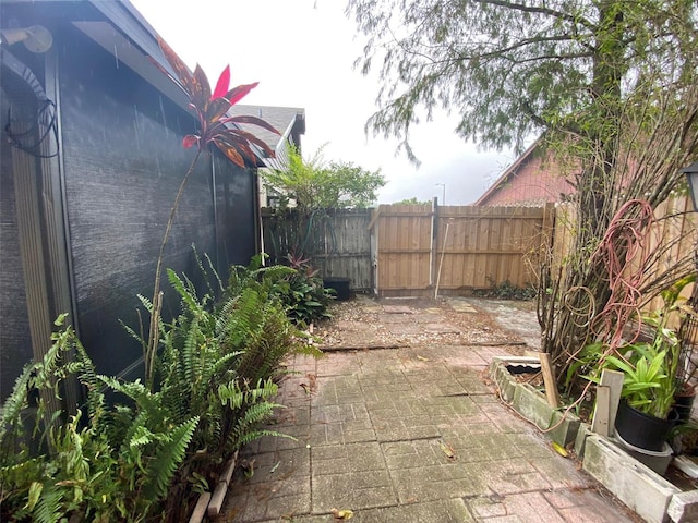 view of yard with fence and a patio