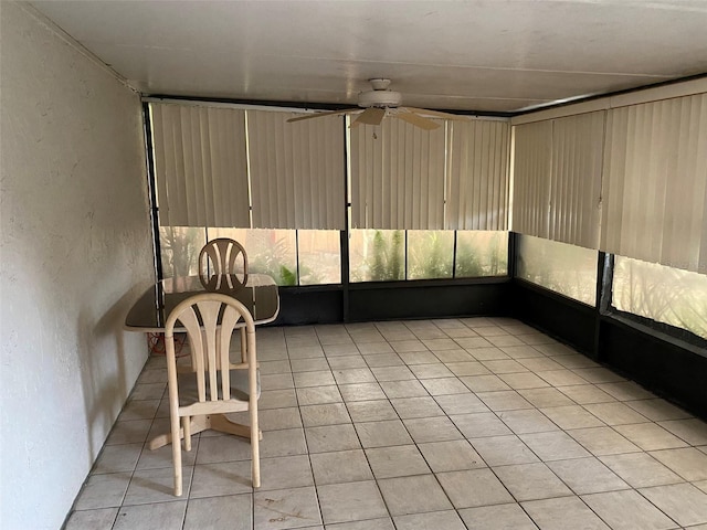 unfurnished sunroom with a ceiling fan