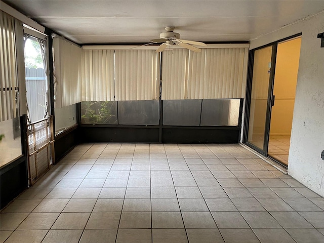 unfurnished sunroom with a ceiling fan