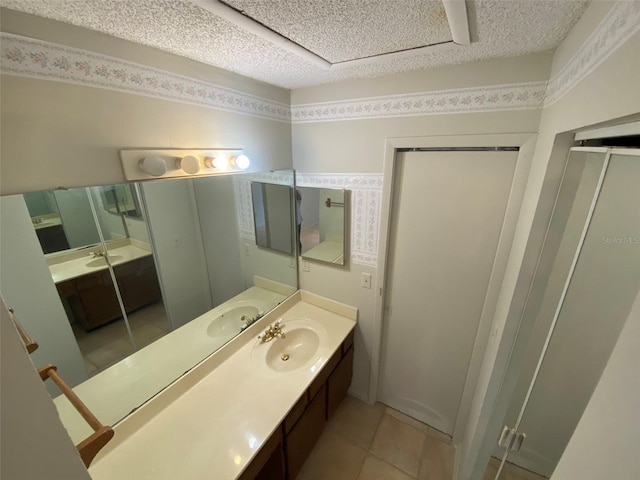 bathroom featuring a textured ceiling, vanity, and tile patterned flooring