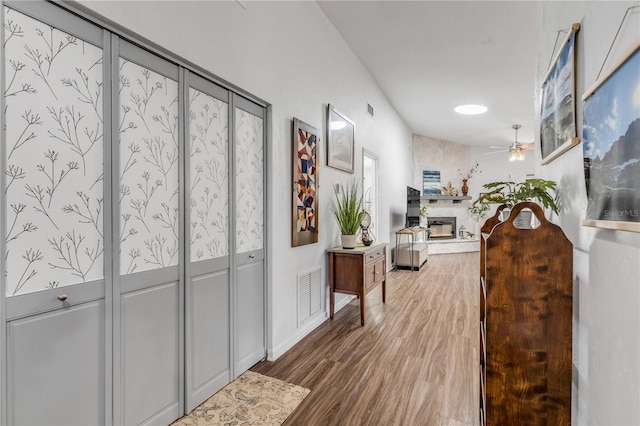 hallway with hardwood / wood-style flooring