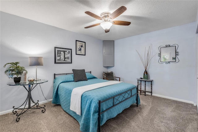 bedroom featuring ceiling fan, carpet floors, and a textured ceiling