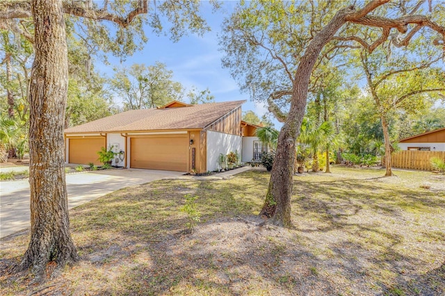 view of property exterior featuring a garage and a lawn