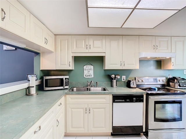 kitchen featuring appliances with stainless steel finishes, sink, and white cabinets