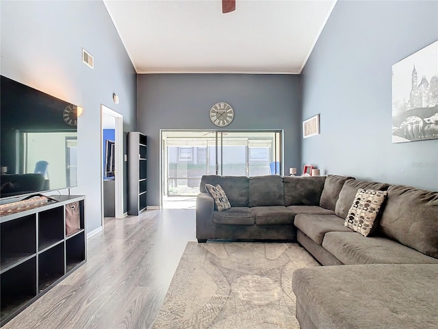 living room featuring hardwood / wood-style flooring and crown molding