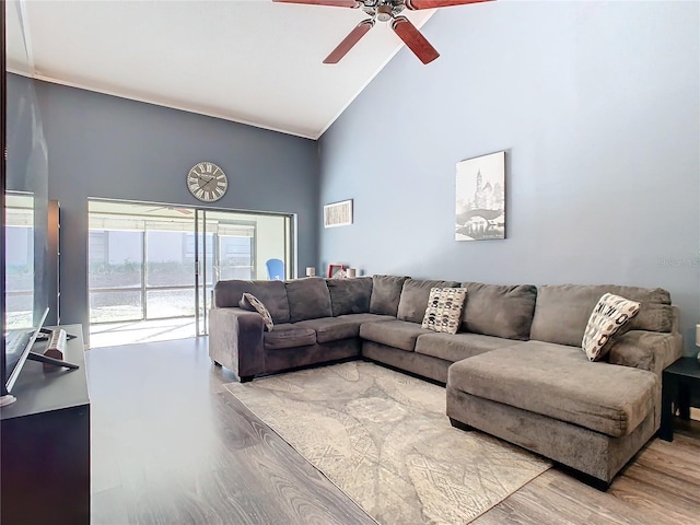 living room with hardwood / wood-style floors, high vaulted ceiling, and ceiling fan