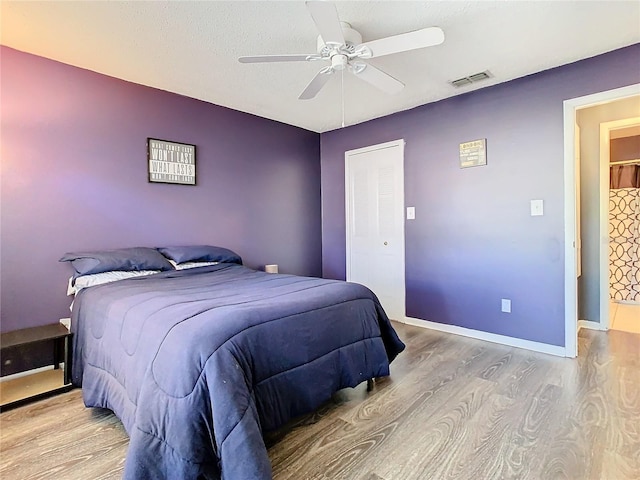 bedroom featuring ceiling fan and light hardwood / wood-style flooring