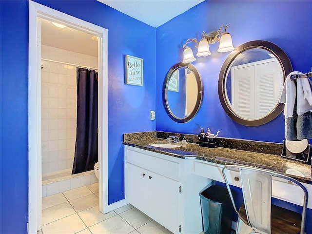 bathroom with vanity, tile patterned floors, toilet, and walk in shower