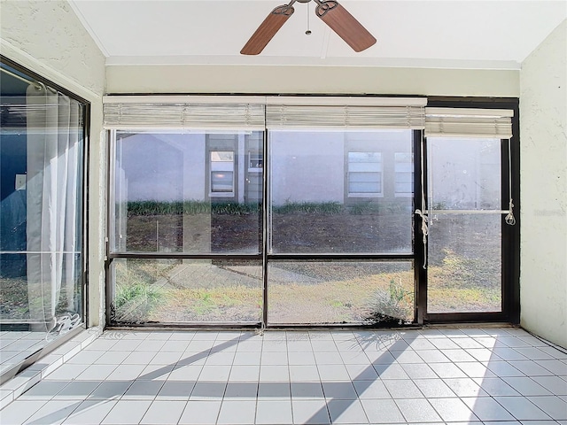 unfurnished sunroom with a wealth of natural light and ceiling fan