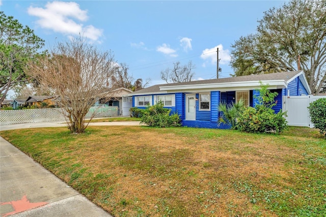 ranch-style home with a front lawn