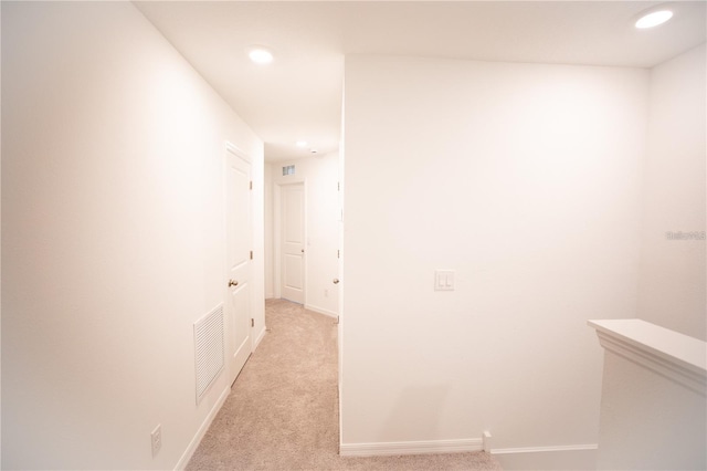 hallway with light colored carpet