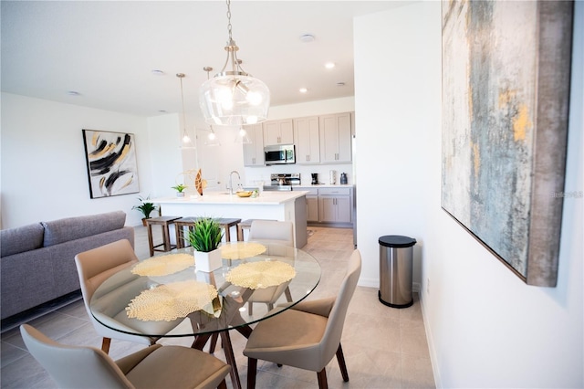 tiled dining space featuring sink