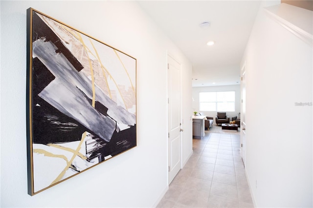 hall featuring light tile patterned flooring