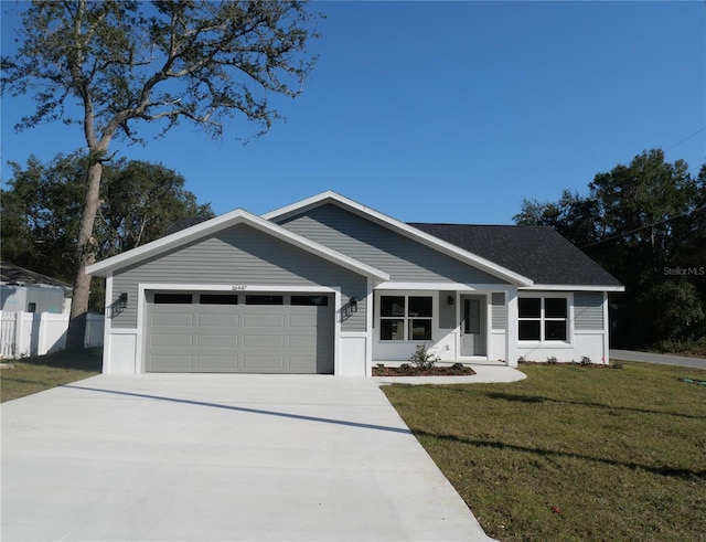 ranch-style home featuring a garage and a front lawn