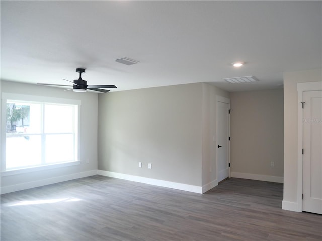 spare room with ceiling fan and dark hardwood / wood-style flooring