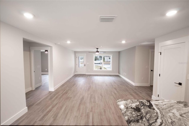 unfurnished living room with ceiling fan and light hardwood / wood-style floors