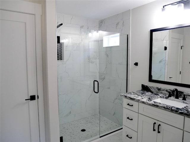 bathroom with vanity and a shower with shower door