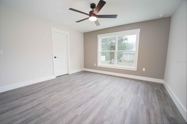 empty room with ceiling fan and light wood-type flooring