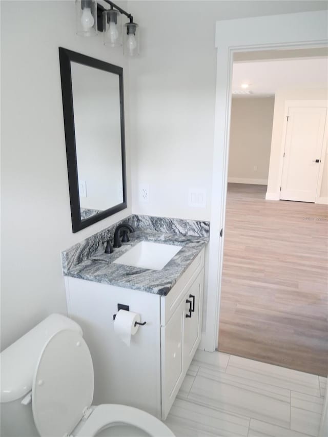 bathroom with vanity and toilet