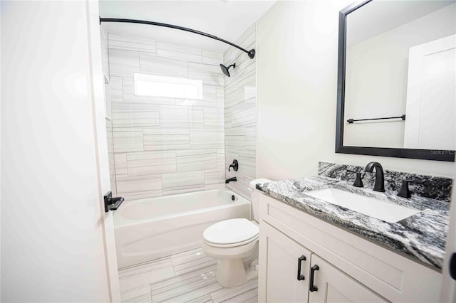 full bathroom featuring vanity, toilet, and tiled shower / bath combo