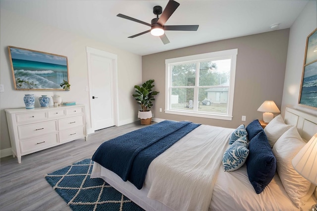 bedroom with ceiling fan and light hardwood / wood-style flooring