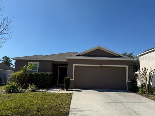 view of front of house featuring a garage and a front lawn