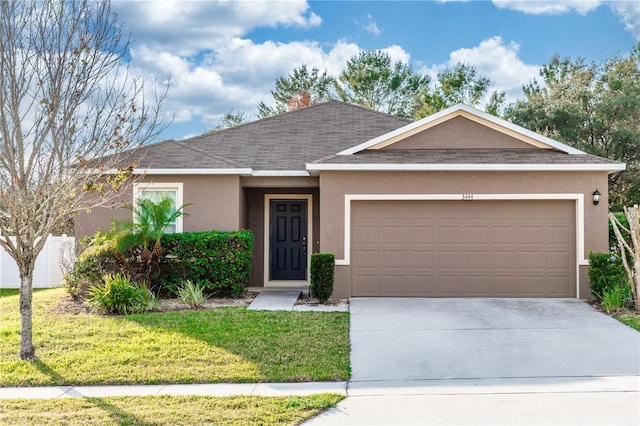 single story home featuring a garage and a front lawn