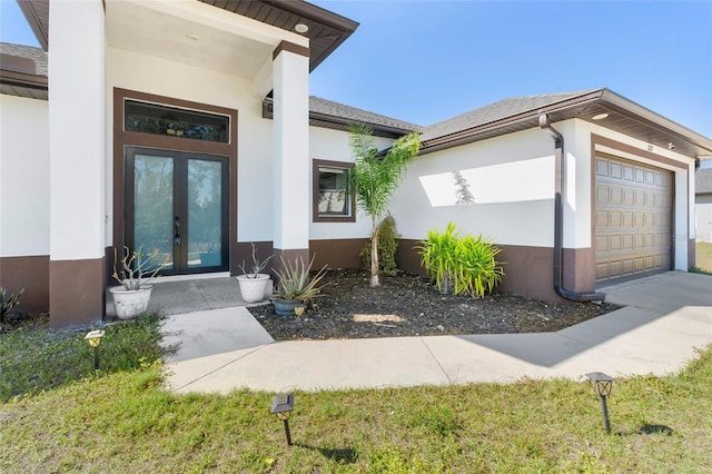 property entrance with a garage and french doors