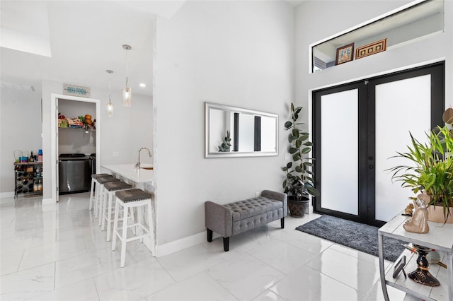 foyer entrance with french doors and a high ceiling