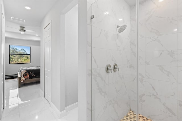 bathroom featuring a tile shower and ceiling fan