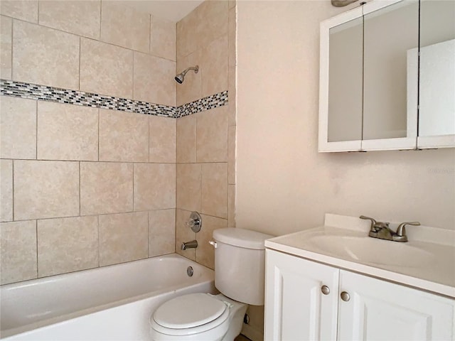 full bathroom with vanity, tiled shower / bath, and toilet