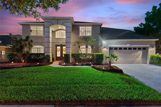 view of front facade with a yard and a garage