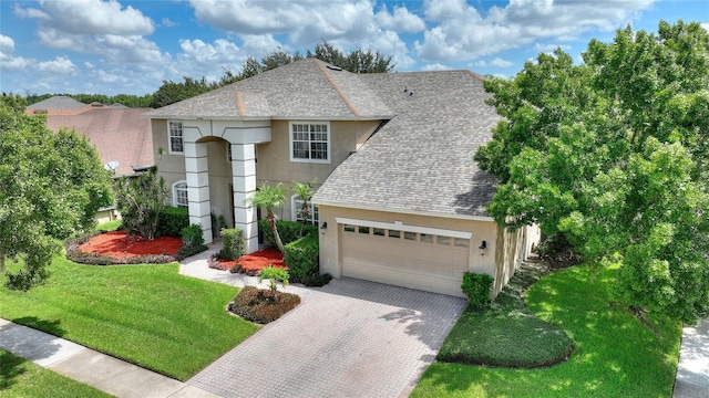 view of front facade with a garage and a front yard