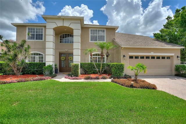 view of front of house with a garage and a front yard