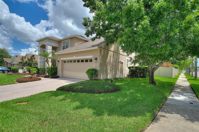 view of front of house featuring a garage and a front lawn