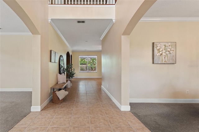 corridor with crown molding and light tile patterned flooring