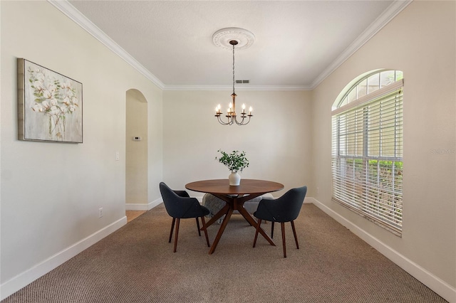 carpeted dining area with an inviting chandelier and crown molding