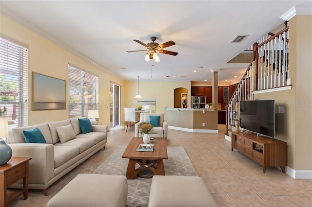 tiled living room featuring crown molding and ceiling fan