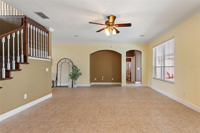 unfurnished living room featuring crown molding, light tile patterned floors, a textured ceiling, and ceiling fan